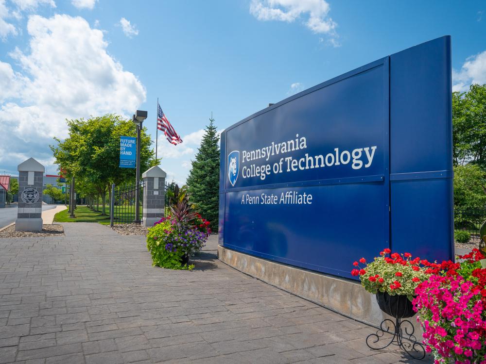 The bright blue entrance sign to Penn College's campus