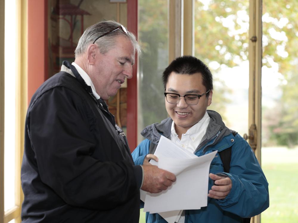 A student networks with a surveying professional during the career summit