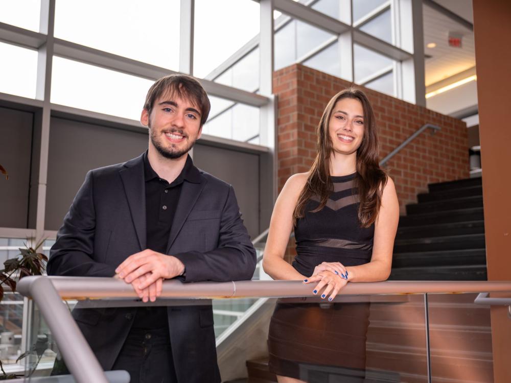 Bond-Rand Technologies founders Andrew Jack Bond and Cadence Rand pose on a stairway in Penn State Behrend's Burke Center.