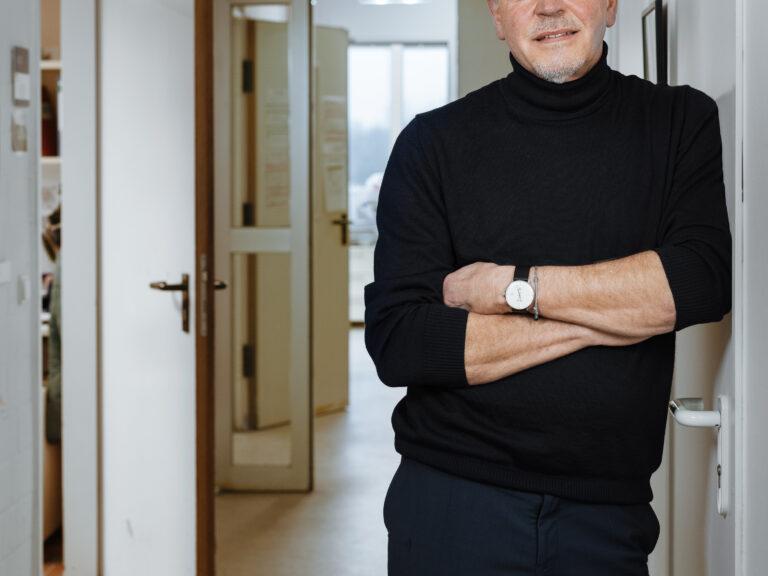 Thomas Bosch stands in front of a hallway.