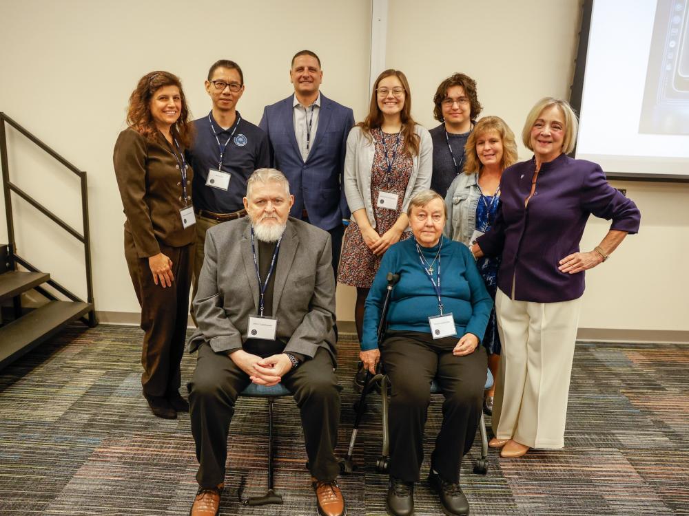 group of people posing for photo in Student Union. 
