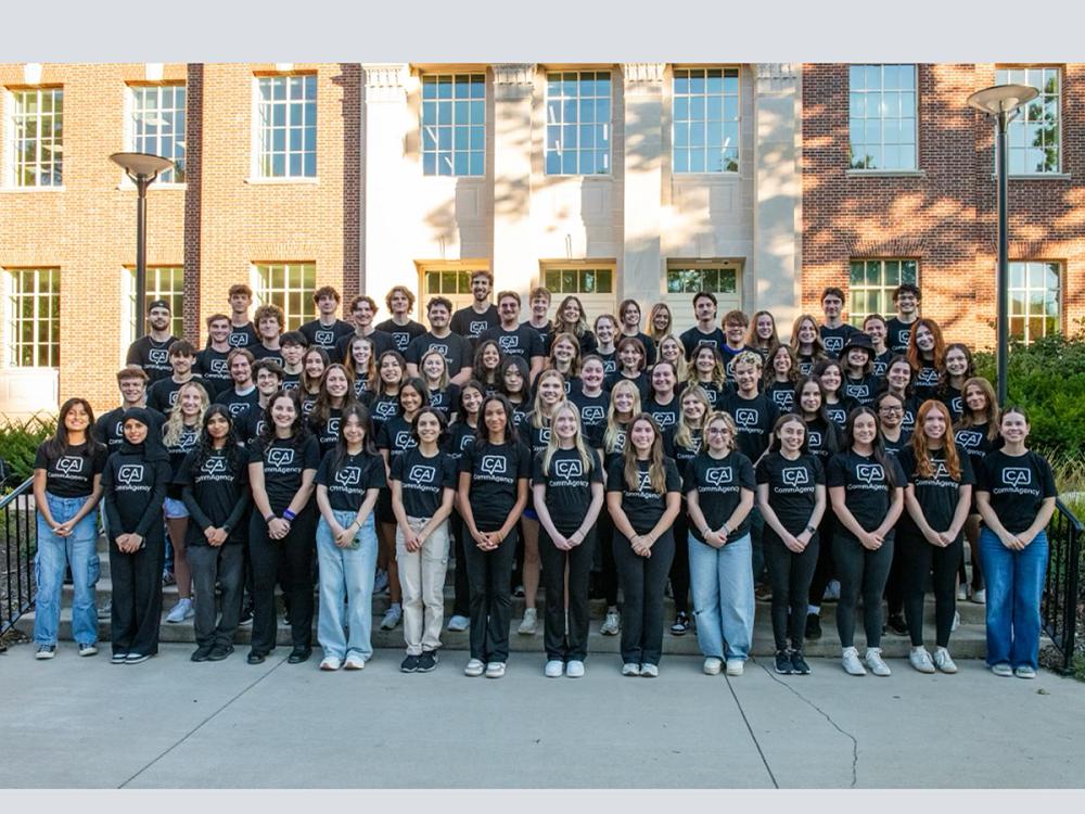 CommAgency students stand together outside