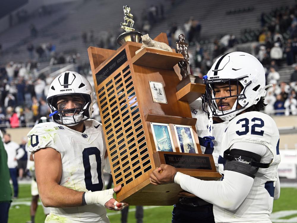 Two people holding trophy