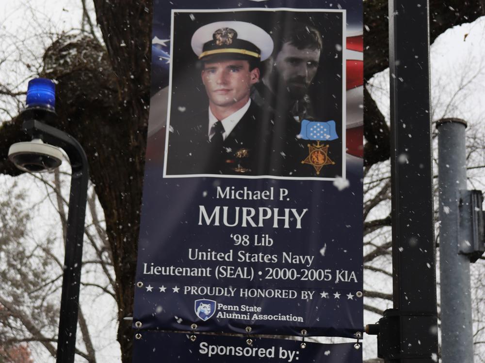 A red, white, and blue banner with a man's photo.