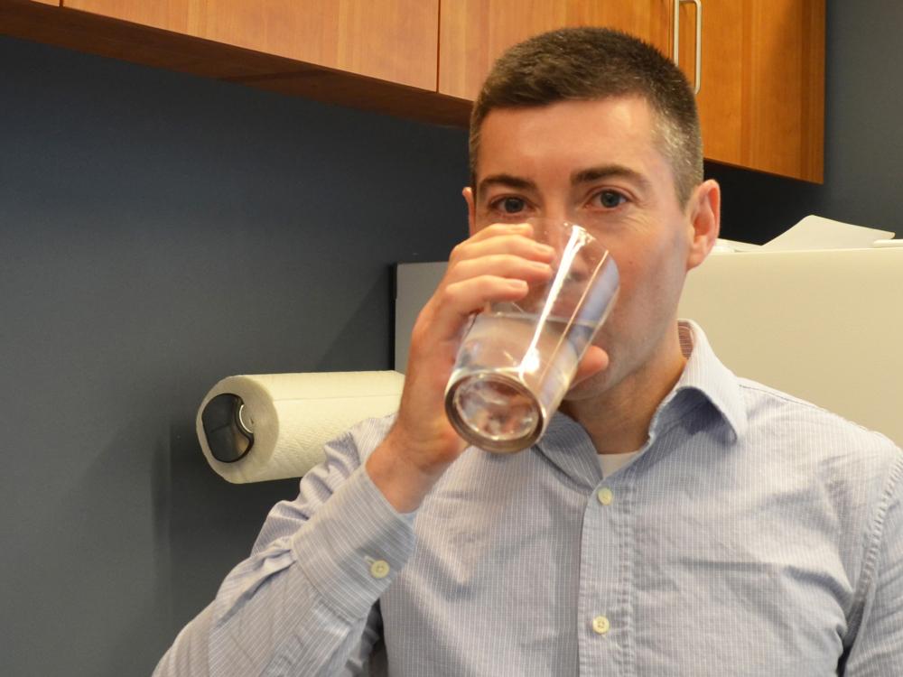 Asher Rosinger drinking a glass of water