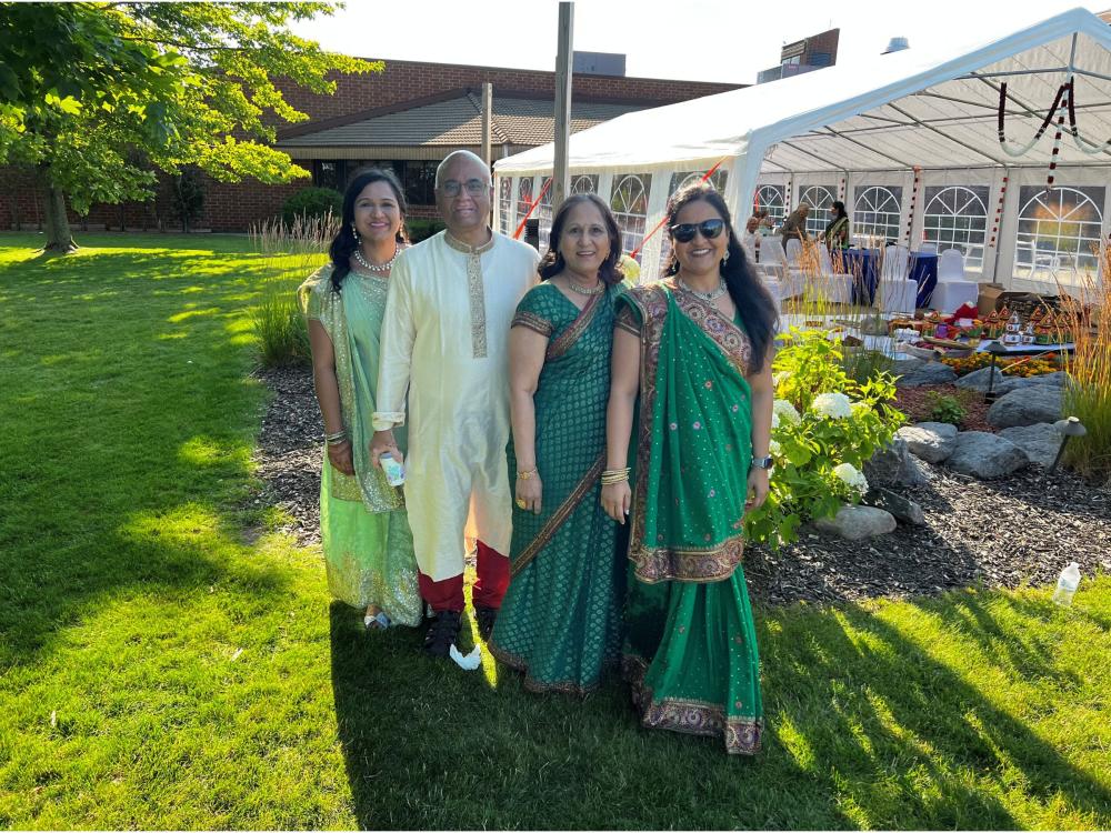 family of four in traditional formal garb at outdoor event