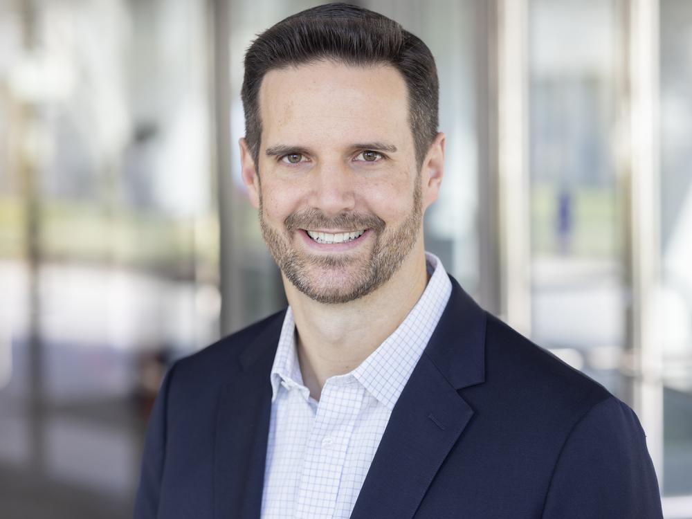 A head and shoulders photo of a smiling Matthew Stuckley