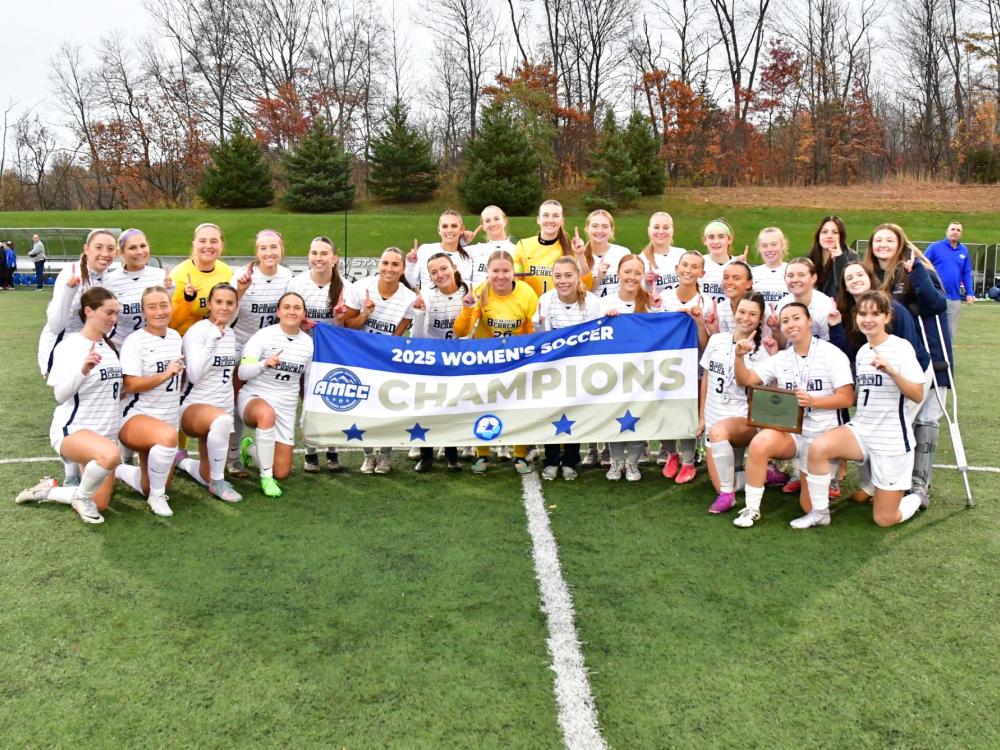 The Penn State Behrend women's soccer team poses with the AMCC championship banner.