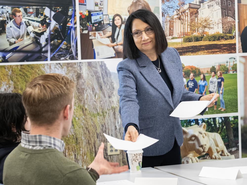Neeli Bendapudi hands out assignments in the class she teaches 