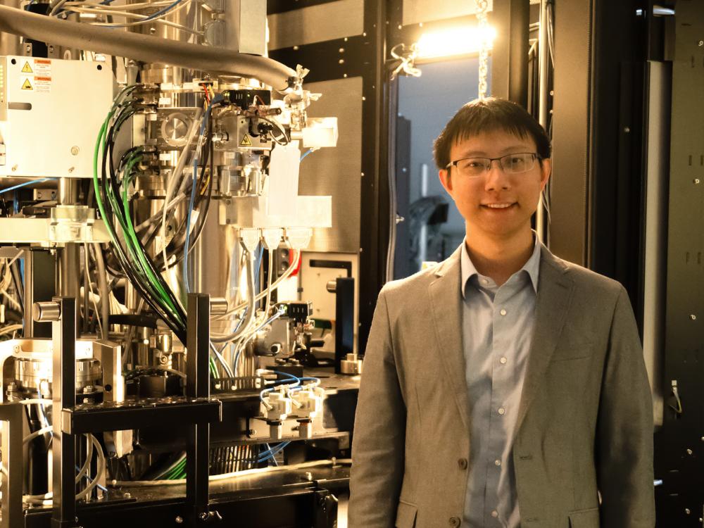 Yang Yang, assistant professor of engineering science and mechanics, poses for a headshot in his lab next to various engineering equipment.