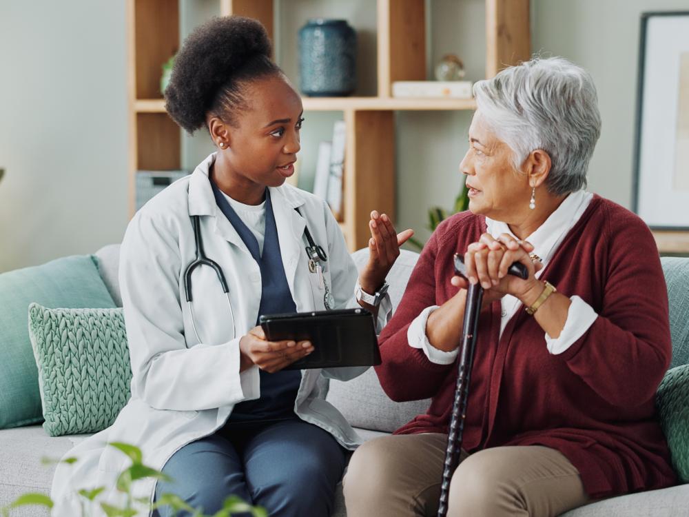 Woman and doctor with tablet for consultation with expert advice, explaining and healthcare support.