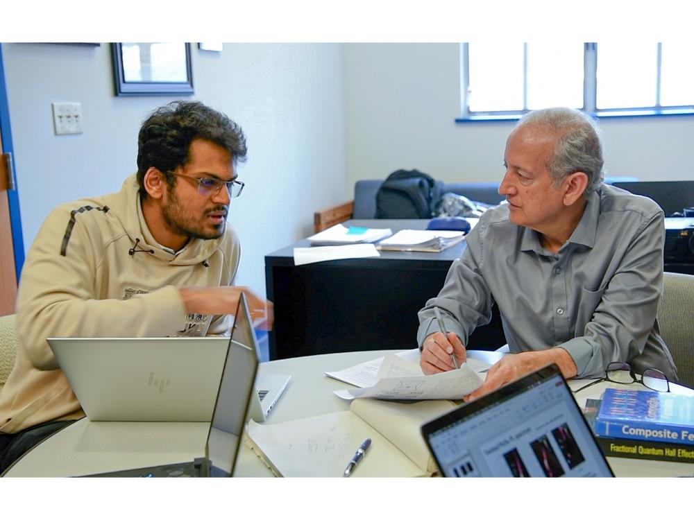 Jainendra Jain works with a student.