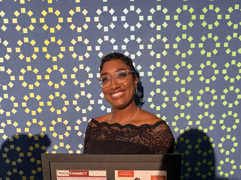 TaTyana Abreu poses for a picture with her Changemaker award