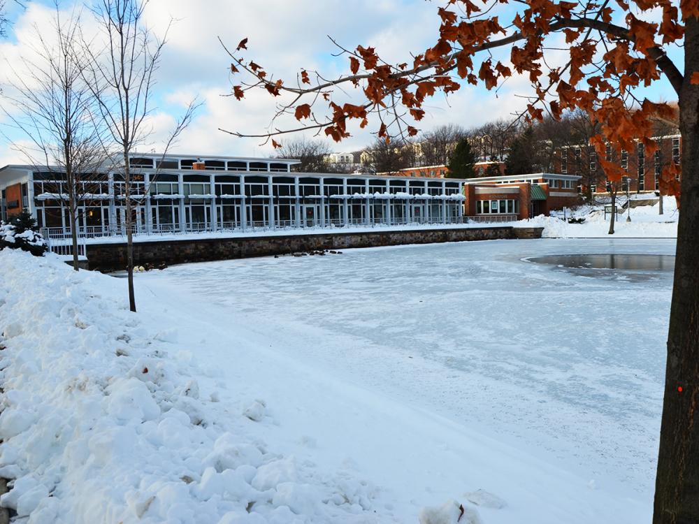 The Slep Student Center at Penn State Altoona on a wintery day, looking out over a frozen reflecting pond