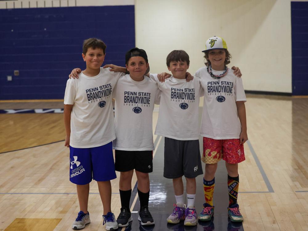 four kids at summer camp in the Brandywine gymnasium