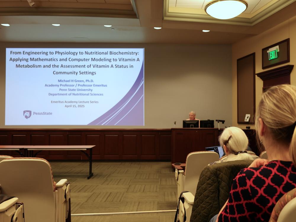 Audience members listen to a lecture from Michael Green