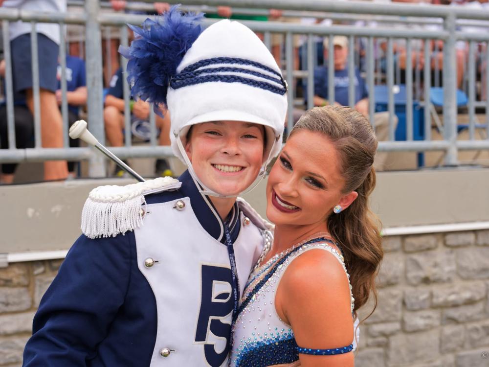 Penn State Blue Band's first female drum major, Ellie Sheehan, and Blue Sapphire, Mackenzie Bronk on field in Beaver Stadium