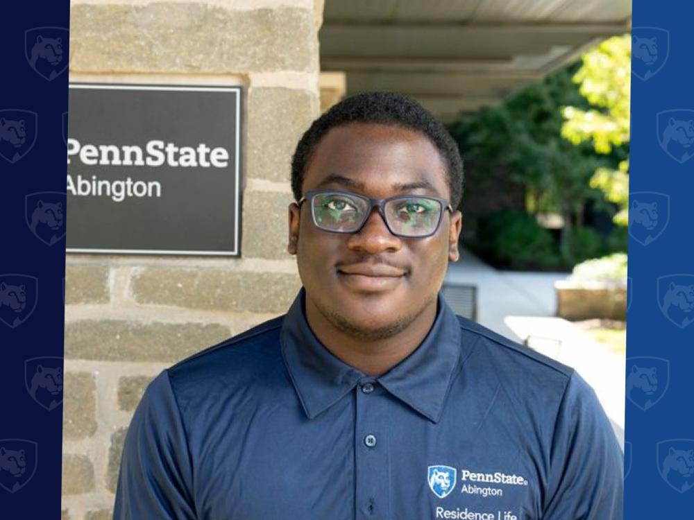 Laurence Orji with a Penn State Abington sign behind him