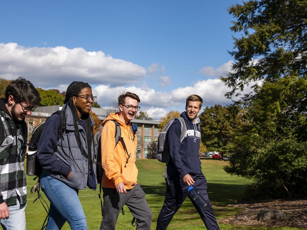 A group of students are walking on campus