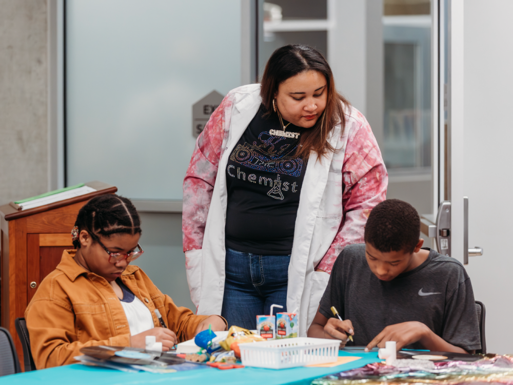 Simpson helps students during a workshop