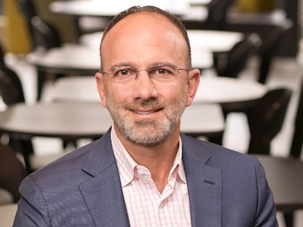 A head and shoulders photo of Gary Brandeis, who is wearing glasses and sporting a beard.