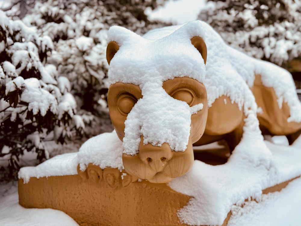 The Nittany Lion shrine is covered with a blanket of snow.