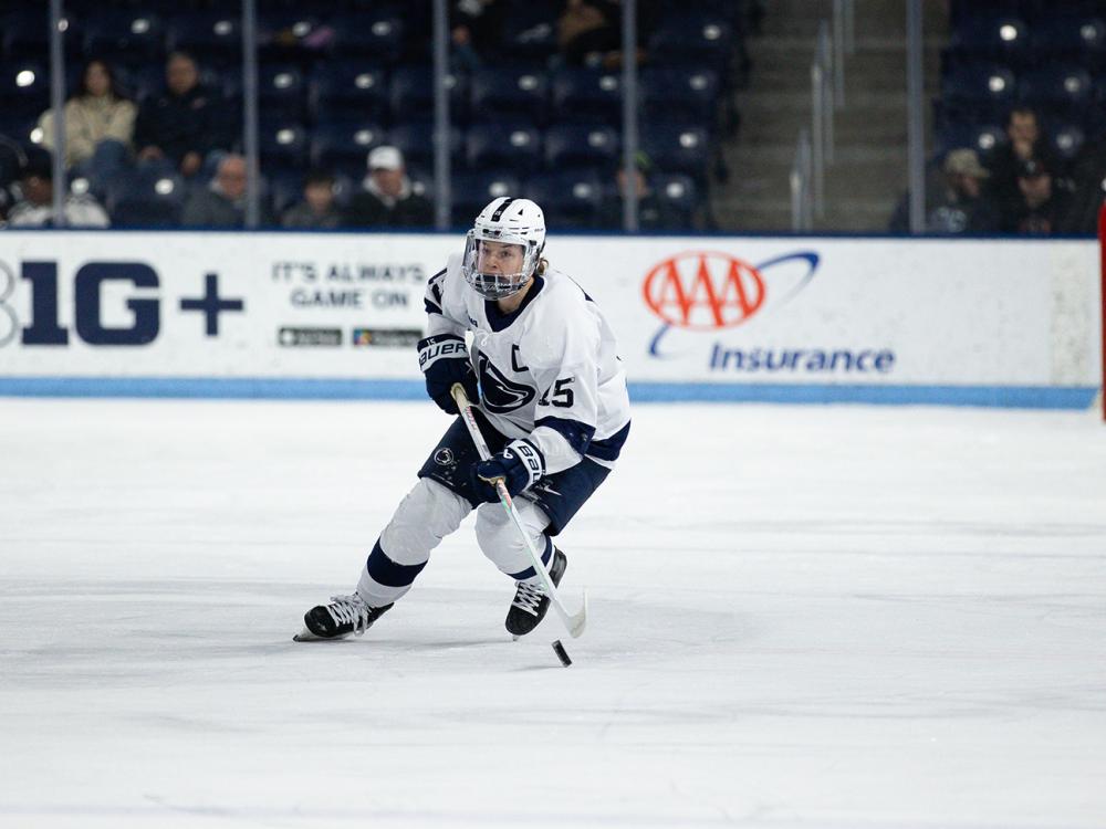 Women's ice hockey player skating