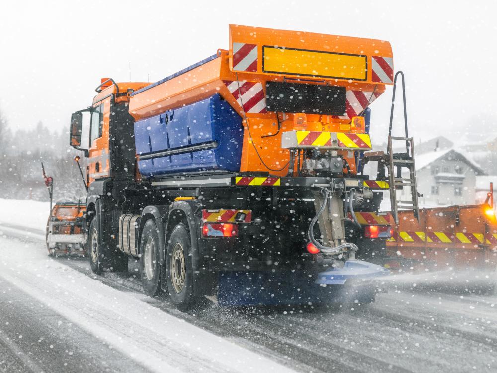 a snow plow clears snow and disperses salt. 
