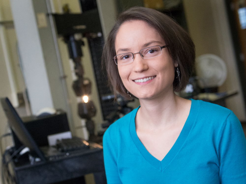 Allison Beese in the foreground, with laboratory instruments in the background