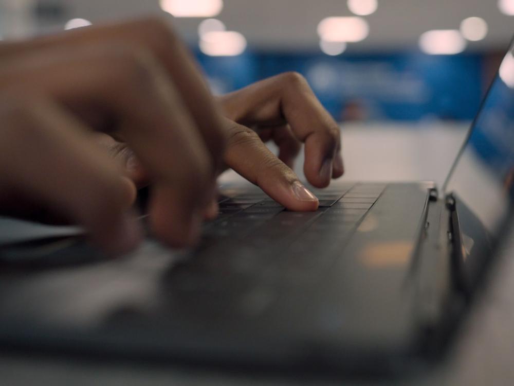 hands typing on laptop