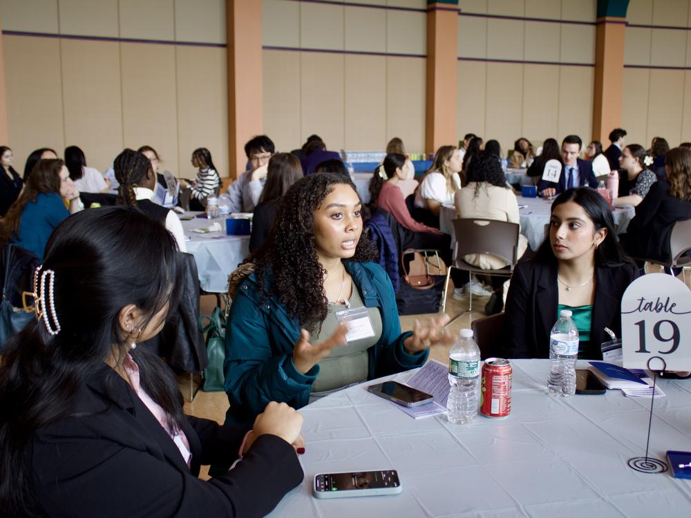 People sitting around tables at a conference