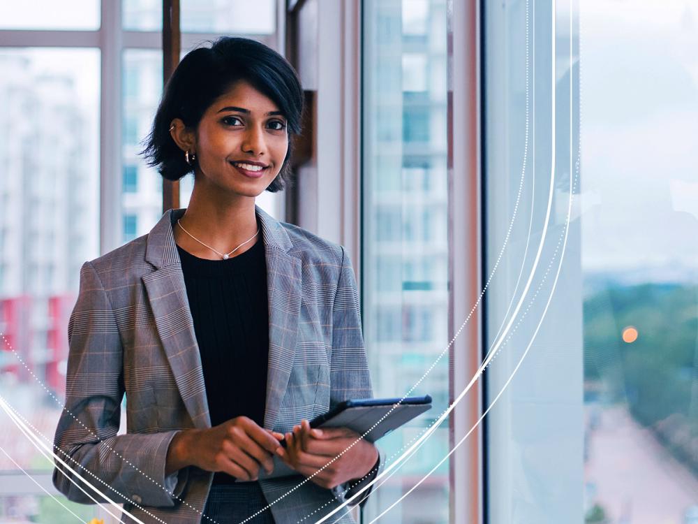 Businessperson standing next to a window