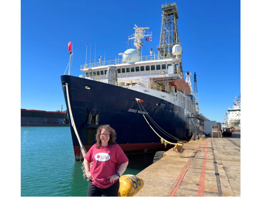 Professor of Earth Sciences at Penn State Brandywine, Laura Guertin, standing in front of scientific research vessel JOIDES Resolution. 