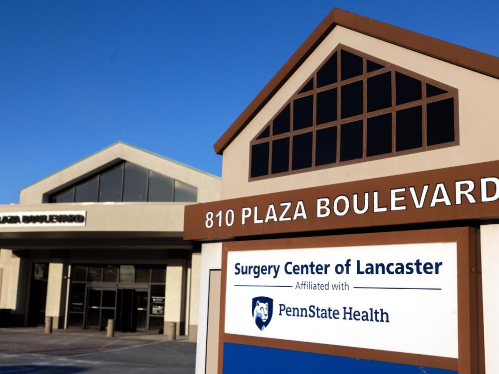 An external photo of Surgery Center of Lancaster, with a sign prominent in the foreground.