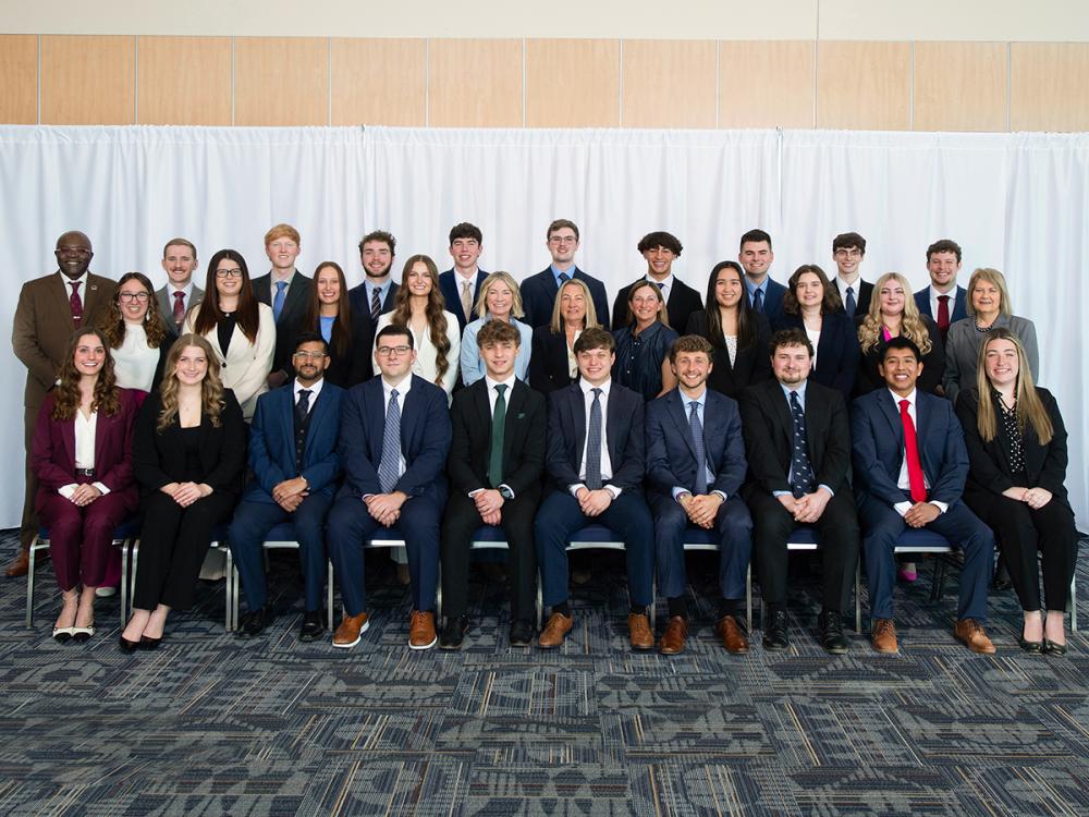 A group of Penn State Altoona students and staff pose for a formal portrait, dressed in business attire as part of the Sheetz Fellows program.