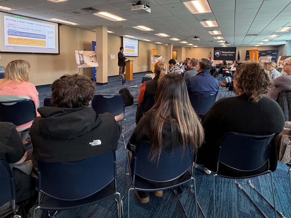 room of people sitting watching a speaker in the front of the room