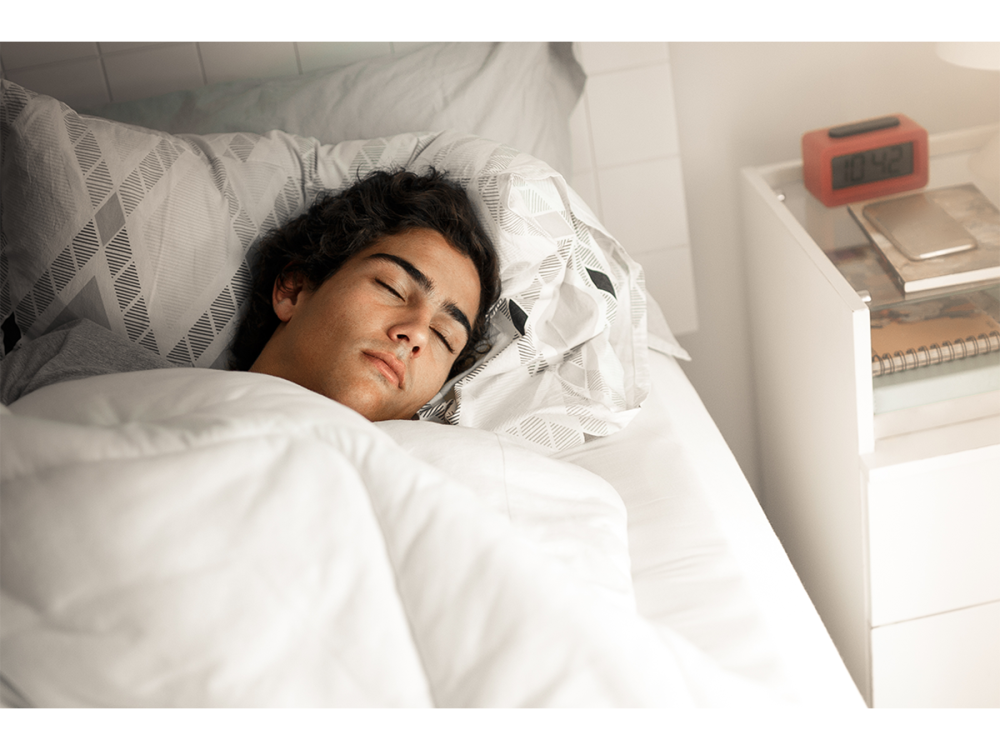 teenager asleep in bed