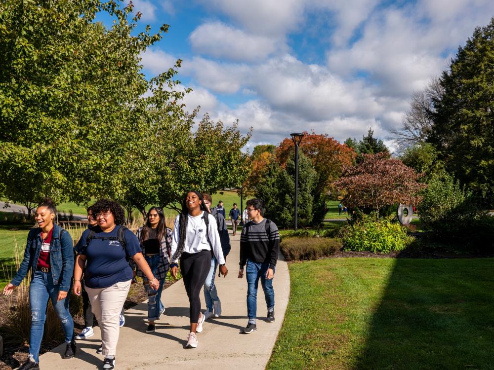A diverse group of students walking through Penn State Berks campus