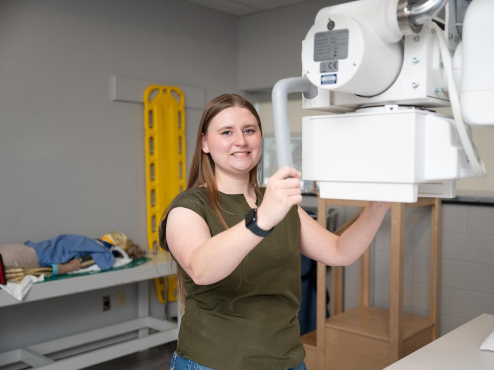A person uses a piece of equipment in a radiography lab