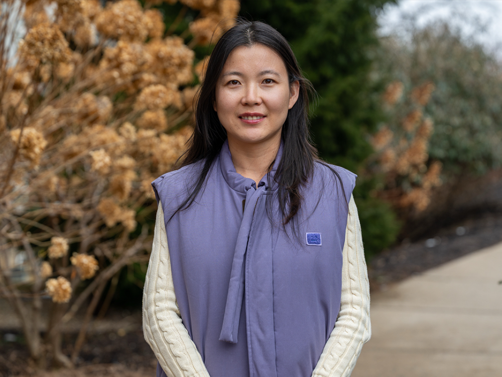 Qian Zhang outside smiling.