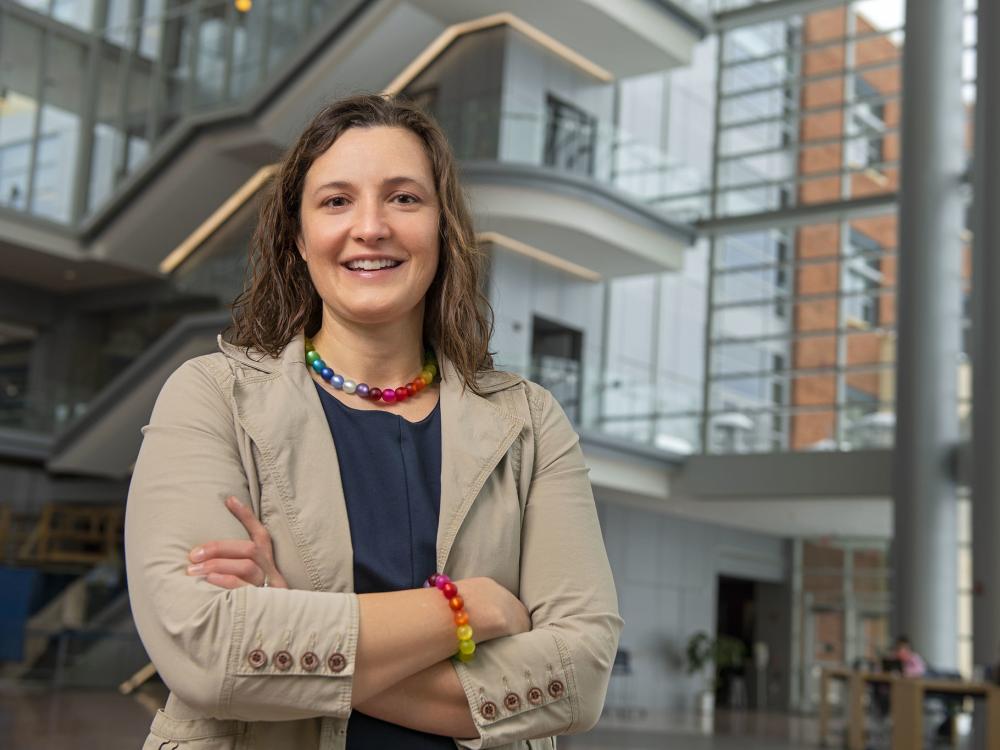 Karen Winterich stands in the Business Building atrium with the steps in the background.