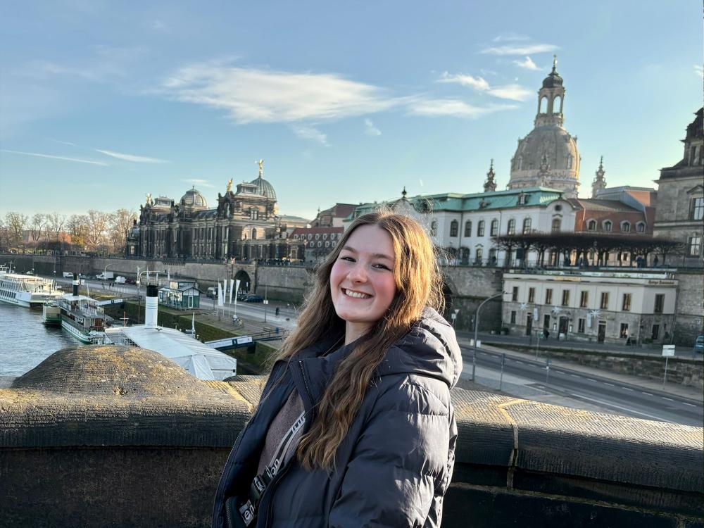 young woman standing on a bridge