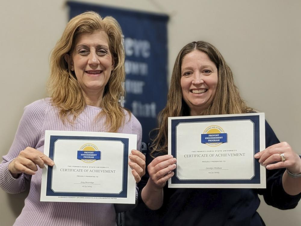 Amy Beveridge and Geralyn Wallace pose for the camera and smile while holding up program completion certificates.