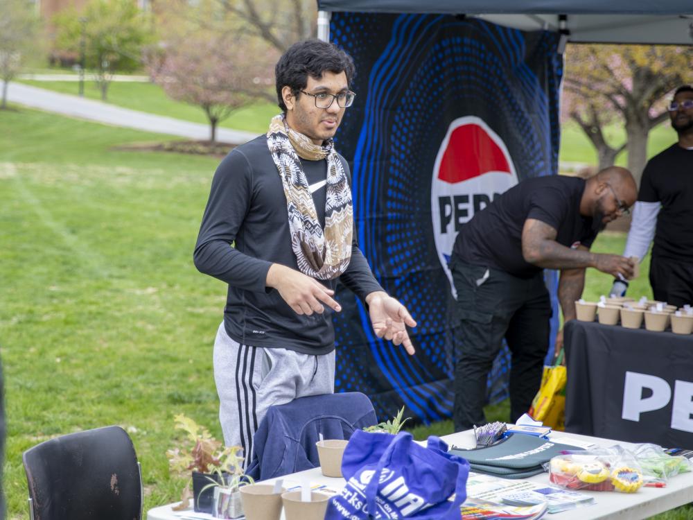 Student at information table at Earth Day event