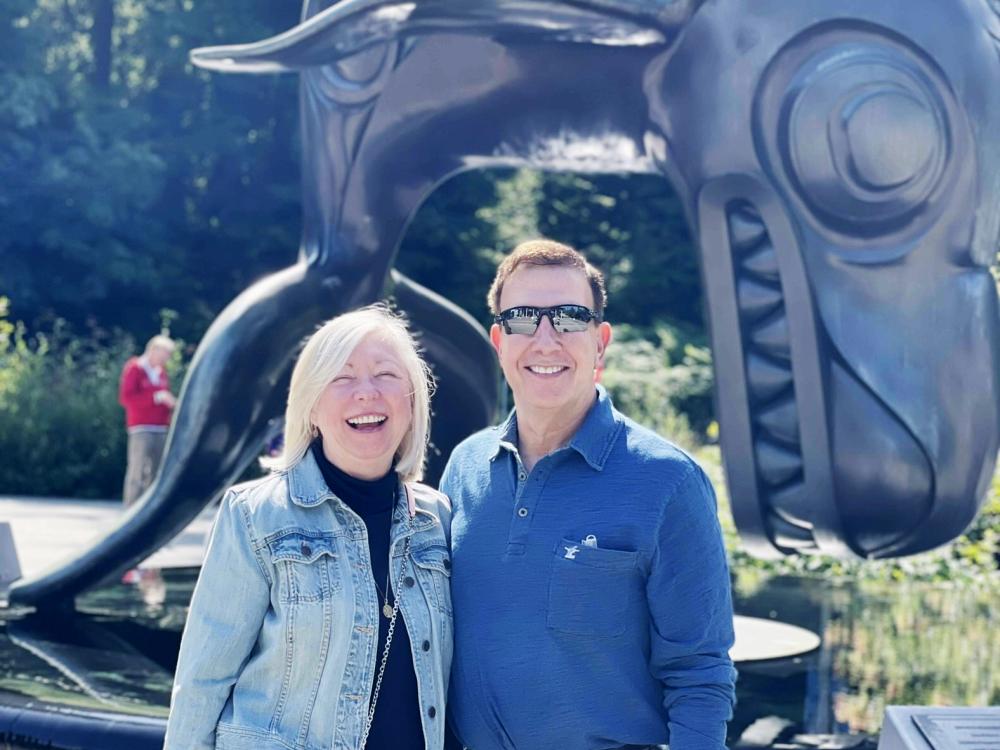 White woman and white man smile while posing for camera