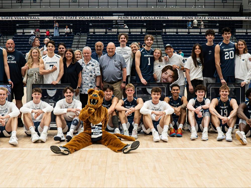 Group photo of team sitting in front of net