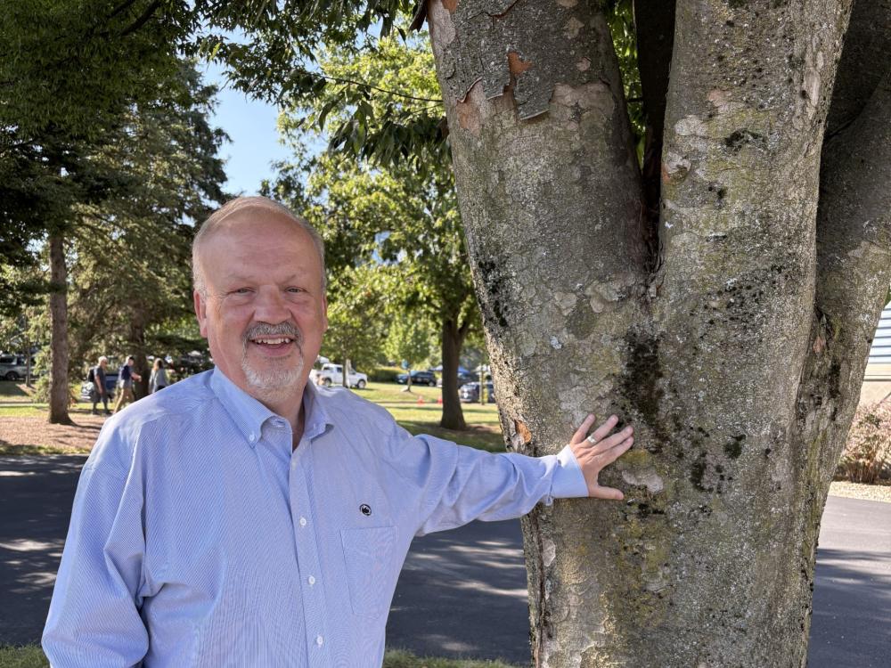Perry Stambaugh with his hand up against a tree