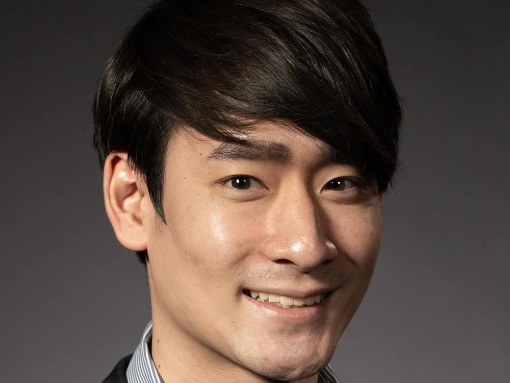 A head shot of a smiling Masashi Takahashi