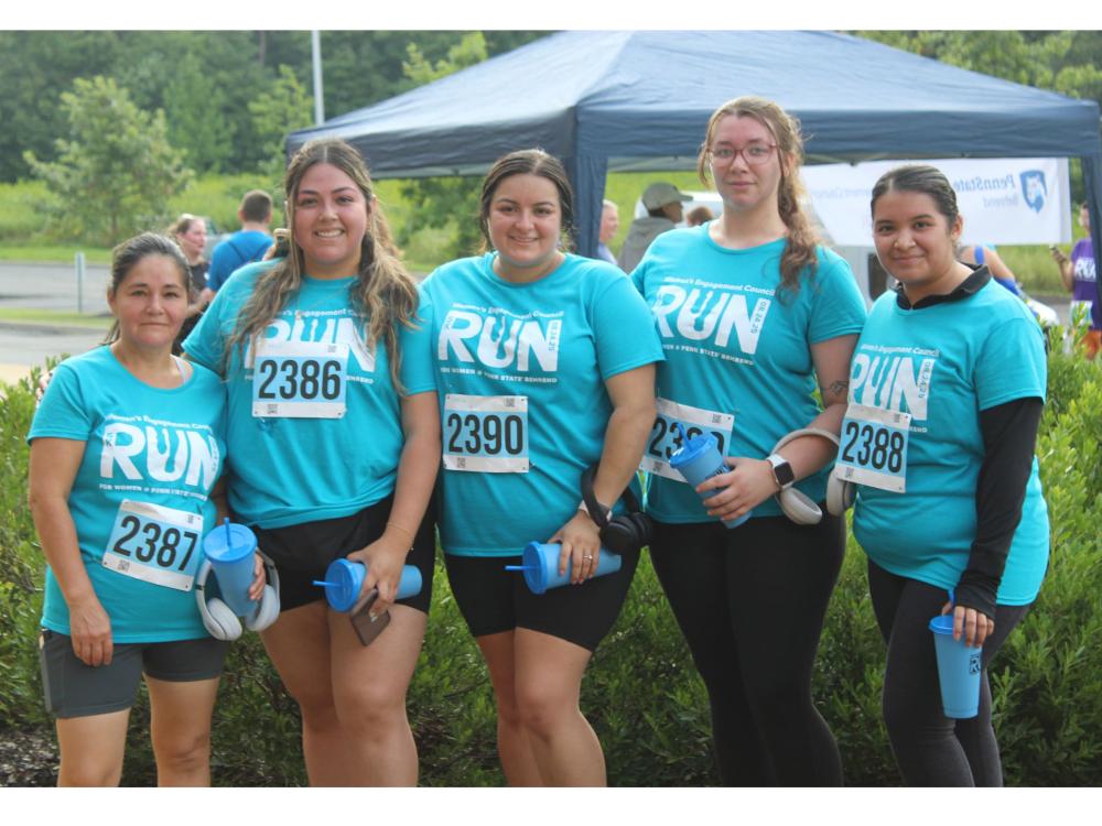 Several women pose and smile after finishing the WEC Run for Women 5K at Penn State Behrend