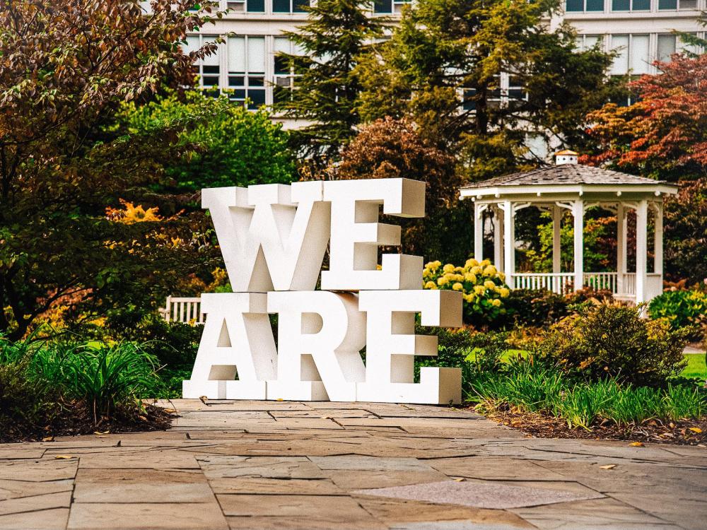 "We Are" block letters on lawn in front of gazebo